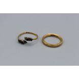 Two 22 carat gold rings. Comprising a size N wedding band and a cut shank gem set ring. Total weight