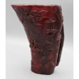 A Chinese carved horn libation cup, decorated with figures, pagodas and trees. 21.5cm