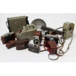 A small collection of cameras including a kodak retinal and two vintage cine cameras, a Geiger