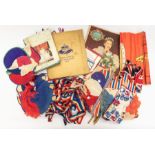 A collection of mid-century commemorative decorations including crepe paper hats and headdresses