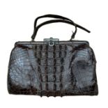 A late 19th/ early 20th crocodile skin bag with sliding clasp and leather lining. aprox 25 x 15