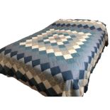 A tumbling block design cot quilt or wall hanging, hand sewn from Liberty fabrics, a pieced double