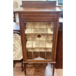 An Art Nouveau mahogany inlaid display cabinet, quarter back gallery on a slight overhanging top,