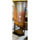 A George III oak corner cupboard, bow front, twin panel doors, enclosing interior shelves. 89cm H;