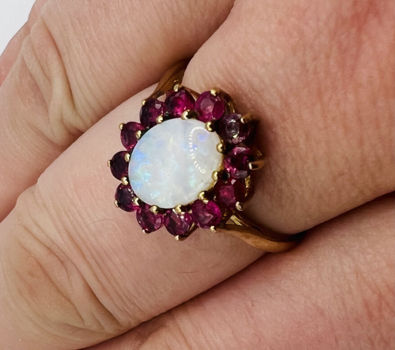 A 9ct gold Opal and ruby cluster ring with matching earrings. The opal featured in ther ring is en - Image 6 of 6