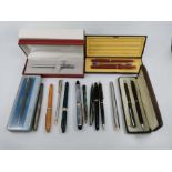 A selection of fountain pens, ballpoint pens and pencils by Shaeffer, Waterman, Hallmark and