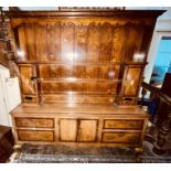 A George III oak and mahogany inlaid dresser, moulded cornice above three tier shelves flanked by