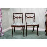 A pair of Regency period faux rosewood and gilt me