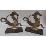 A large pair of brass 20th C mythical rearing horse door stops on marble bases, standing 28cm