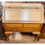 A mid 20th century teak bureau, foliage carving th