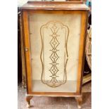 A 20th Century mahogany glazed cabinet, serpentine top above a glazed inlay door, enclosing glass