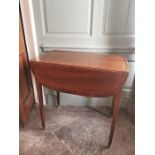 An Edwardian mahogany and inlaid Pembroke table on brass castors with a drawer in one end.