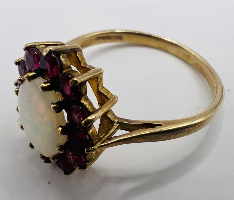 A 9ct gold Opal and ruby cluster ring with matching earrings. The opal featured in ther ring is en - Image 4 of 6