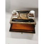 A C1900 Coromandel wooden double inkstand with two glass inkwells and a brass handle to the centre.