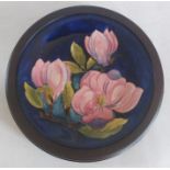 A Moorcroft orchid pattern tube lined circular dish, impressed "Moorcroft", made in England,