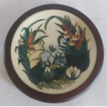 A similar contemporary dish with tube lined waterlilies and bulrushes, impressed marks and WM c95 in