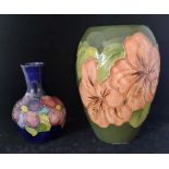 A Moorcroft baluster vase "coral hibiscus" design on a green ground, 18cm high and a Moorcroft pansy