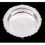 A George  V plain silver circular bowl, scallop edge on four stylised paw feet, hallmarked by George