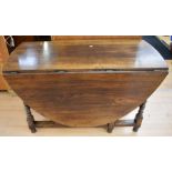 A 19th century oak dropleaf table with end drawer, gate legs, carved detail to sides, together