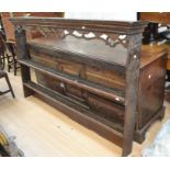 An 18th Century oak George II dresser with plate rack, pierced top, above two shelves, a sit on
