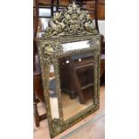 An early 19th Century wall hanging wood and gilt tin mirror with Regency decoration
