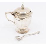 A George V silver ovoid shaped mustard pot and cover, facet body, clear glass liner, hallmarked by