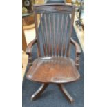 A 1920's mahogany swivel chair, on four splayed legs