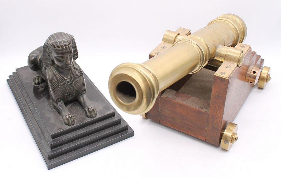 A bronze Sphinx, on marble base, with a brass desktop cannon