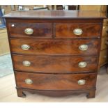 A George III mahogany chest of two above three drawers, on bracket feet, swing handles