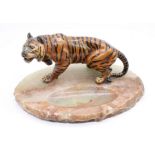 A mid 20th Century onyx based dish with spelter painted tiger detail
