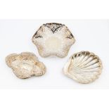 A collection of silver dishes to include; A Sheffield silver shell shaped dish, dated 1891, a