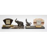 Two Art Deco mantle clocks with elephant and swan detail on marble stands