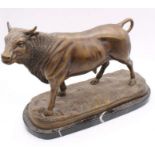 A bronze figure of a bull, on marble stand
