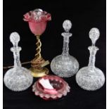 Two large and one small Victorian glass globe decanters, together with a ruby glass dish and a table