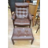 A 1970's brown leather easy armchair, with button back and foot stool