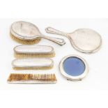 A collection of silver backed dressing table items to include; A matched dressing set of engine