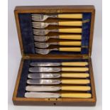 A set of London silver knives and forks with ivorine handles, within wooden case with brass