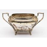 An Art Deco silver two handled sugar bowl, four cabriole legs, hallmarked by James Deakin & Sons,