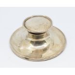 A George V silver capstan ink well of circular form and hinged lid to top, missing glass liner.