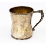A Continental possibly American sterling silver waisted mug, beaded foot rim, foliate handle, gilt