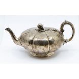 A Victorian silver melon shaped teapot, lobed engraved body, poppy finial, C-scroll handle,