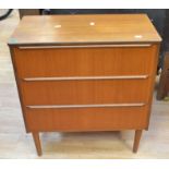 A 1970's teak chest of three drawers on round legs along with teak floor standing dress mirror