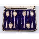 A cased set of Sheffield silver shell designed spoons and matching sugar tongs, hallmarked by C.W.