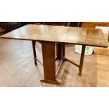 A 20th century oak dropleaf table. 77cm H x 35cm W (152cm with the leaves up) x 92cm D