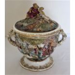 A Naples porcelain twin handled cup and cover, 20th century, moulded in relief with scenes from