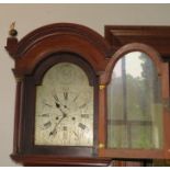 A George III mahogany longcase clock, the hood with arched top flanked by reeded brass capped