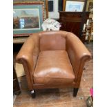 Brown Leather tub chair. Leather faded through sun bleaching