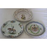 A 19th century French faience plate painted in polychrome with a knight on horseback, floral border,