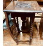 A 20th Century carved oak table, square top with a