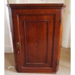 A George III oak hanging corner cupboard with inlaid shell patear. With 2 enclosed shelves, stands